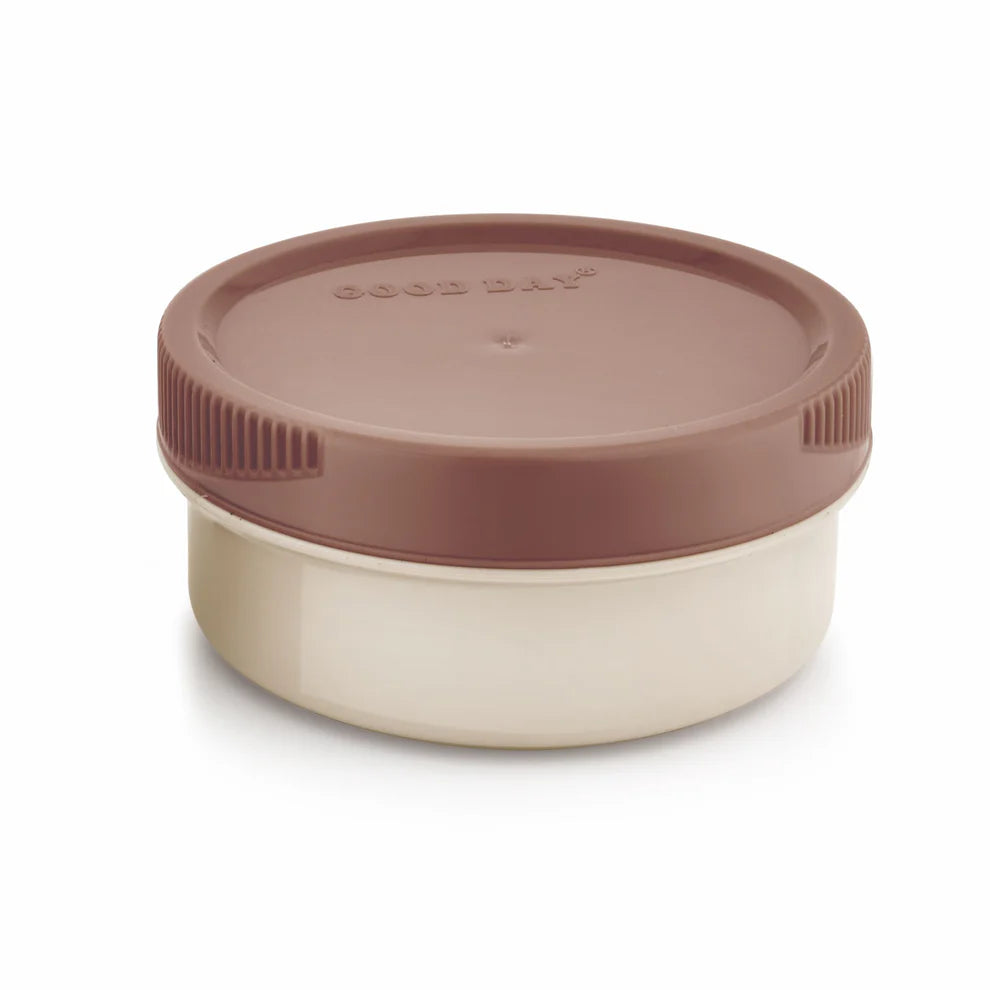 A Good Day round food storage container with a brown screw-top lid and a cream-colored body, shown on a white background.