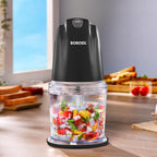 Borosil electric mini chopper with a transparent bowl filled with freshly chopped vegetables, featuring a turbo button and compact countertop design for quick food preparation.