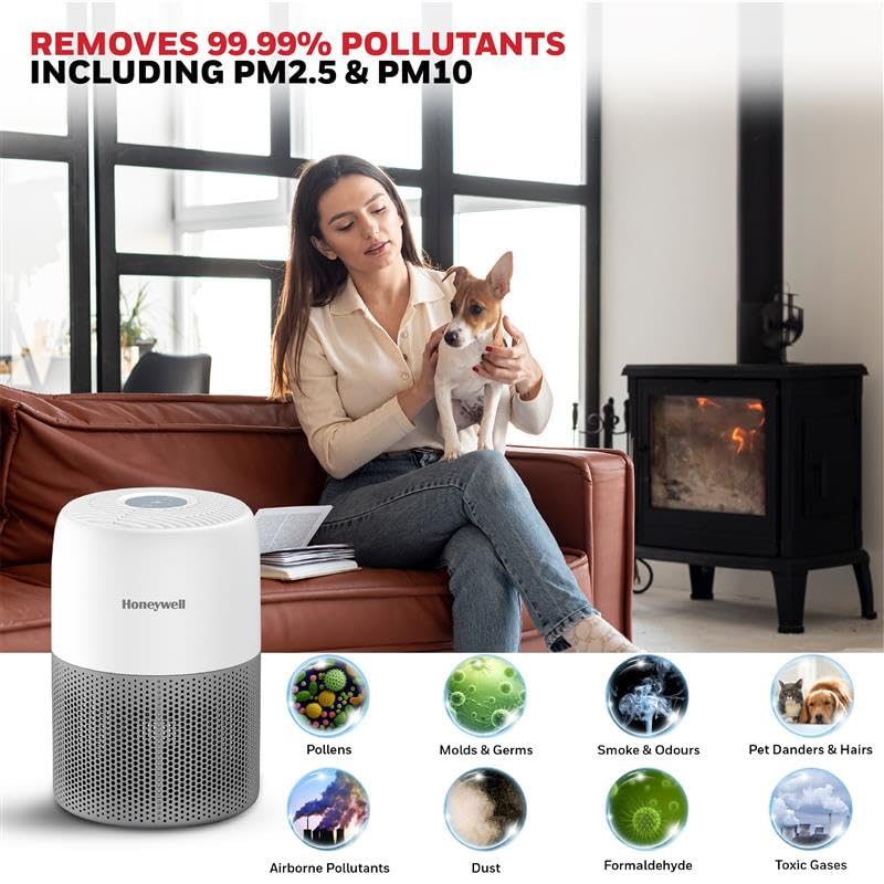Woman holding a dog in a living room with a Honeywell air purifier and pollutant removal features displayed.