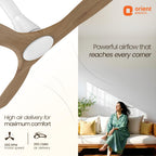 Orient Electric ceiling fan with a woman sitting on a couch in a bright room, featuring text about powerful airflow.