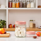 Premium transparent 1500ml glass pantry storage jar with an airtight pink lid, ideal for storing dry fruits, cookies, snacks, spices, coffee beans, honey, pickles, and other kitchen essentials while keeping food fresh and organized.