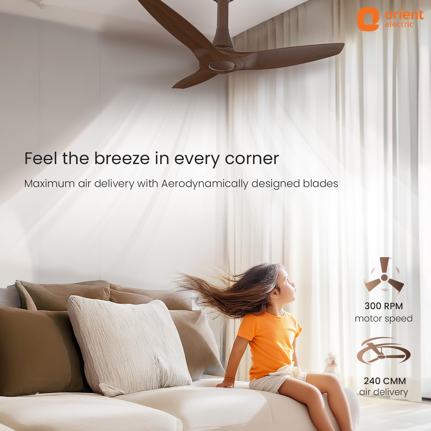 Ceiling fan in a room with a child sitting on a couch, promoting maximum air delivery.