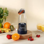 Lifelong Portable USB Rechargeable Juicer Blender with a transparent blending bottle, carrying strap, and stainless steel blades, displayed with fresh fruits including oranges, bananas, kiwi, strawberries, and cherries. Ideal for making smoothies, fresh juices, protein shakes, and healthy drinks on the go.