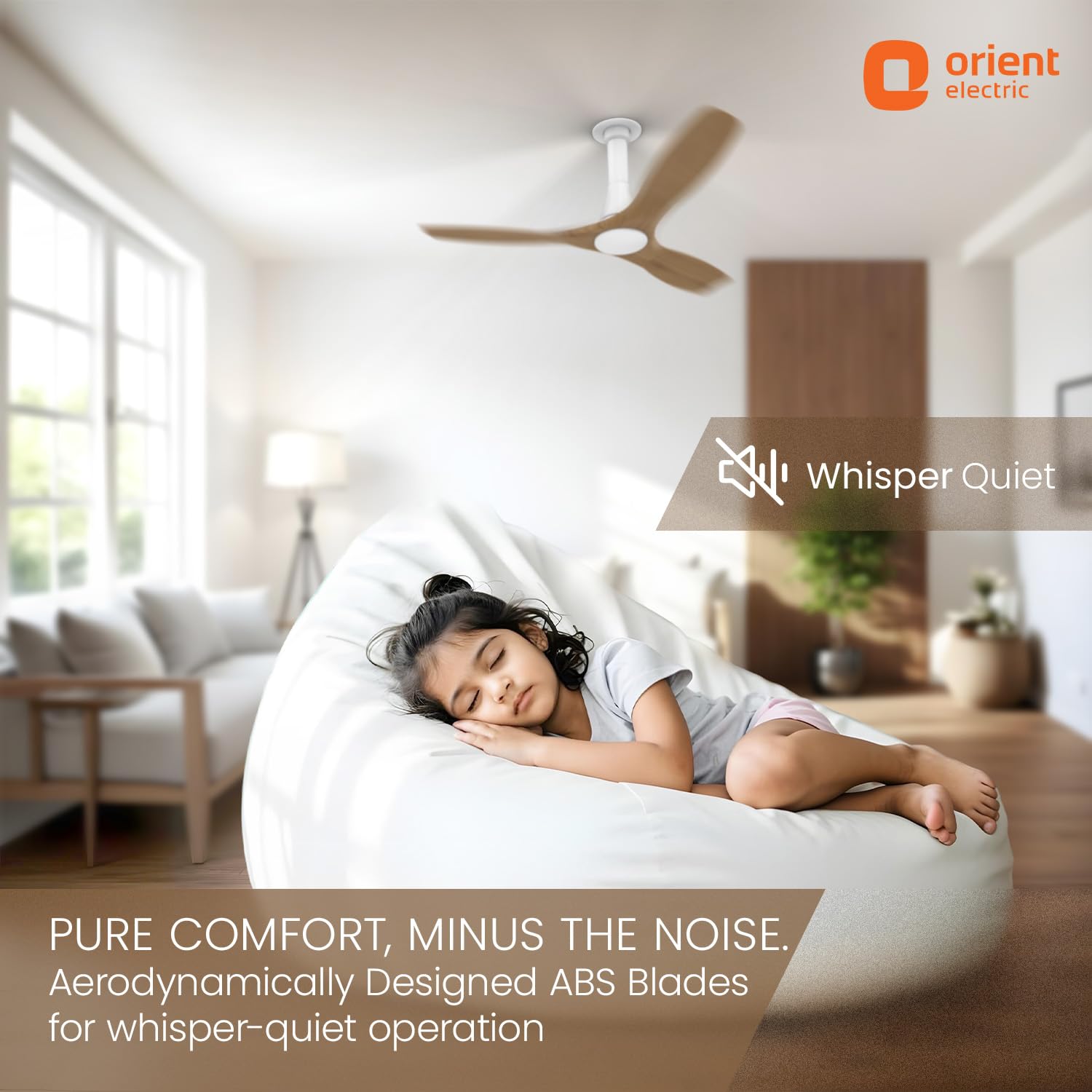 Child sleeping in a bean bag chair with a ceiling fan above, in a room with a couch and window.