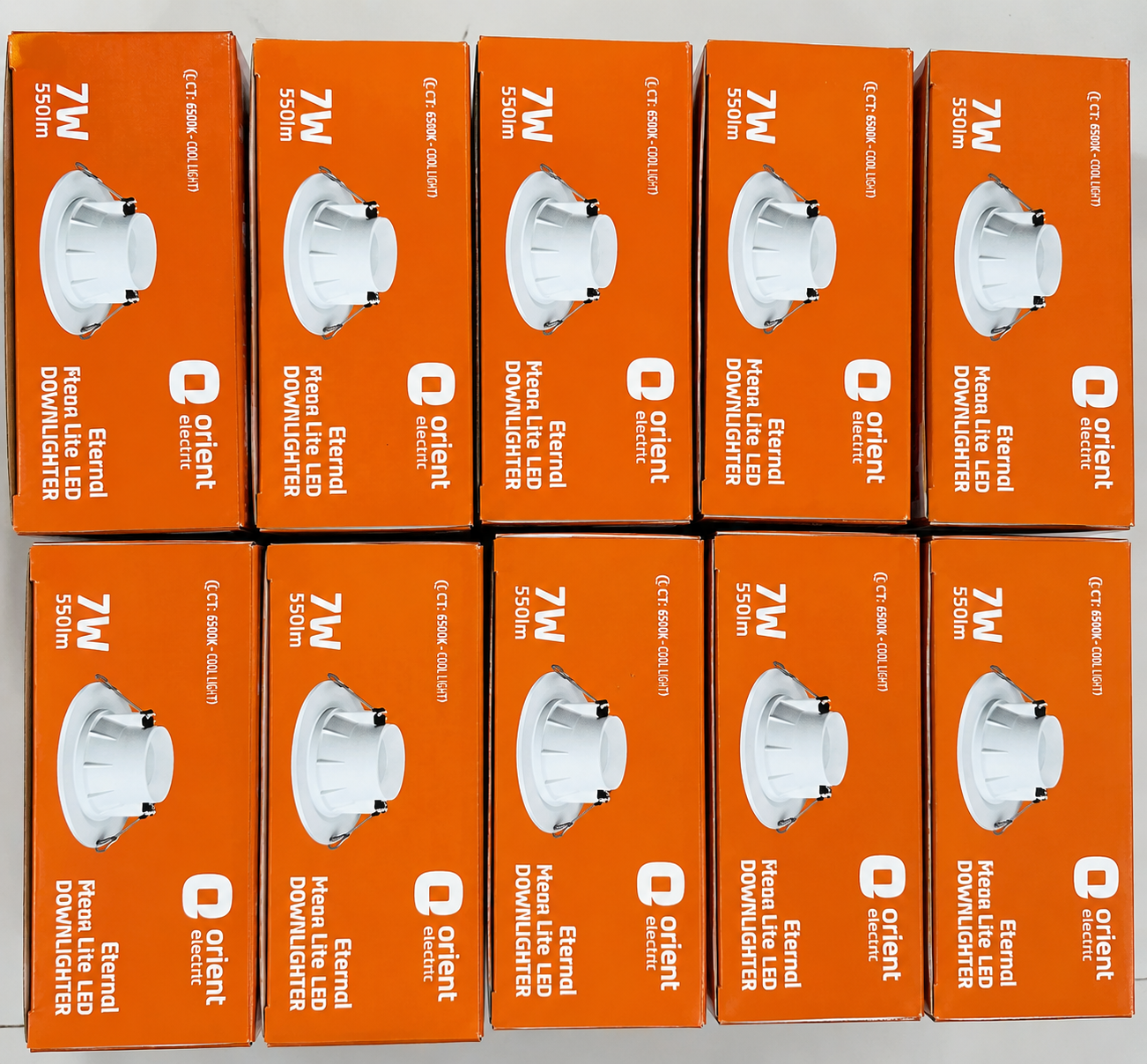 Twelve orange retail boxes of Orient 7W recessed LED downlights arranged in a grid. Each box features a clear window showing the white cylindrical downlight inside.