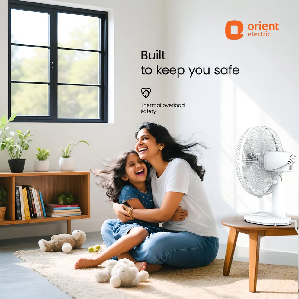 Woman and child playing on the floor with a fan and Orient Electric logo in the background