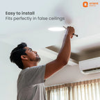 Person installing a light fixture in a ceiling with Orient Electric branding.