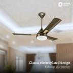 Ceiling fan with electroplated design in a room setting, featuring Orient Electric logo.