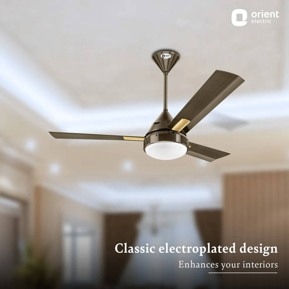 Ceiling fan with electroplated design in a room setting, featuring Orient Electric logo.
