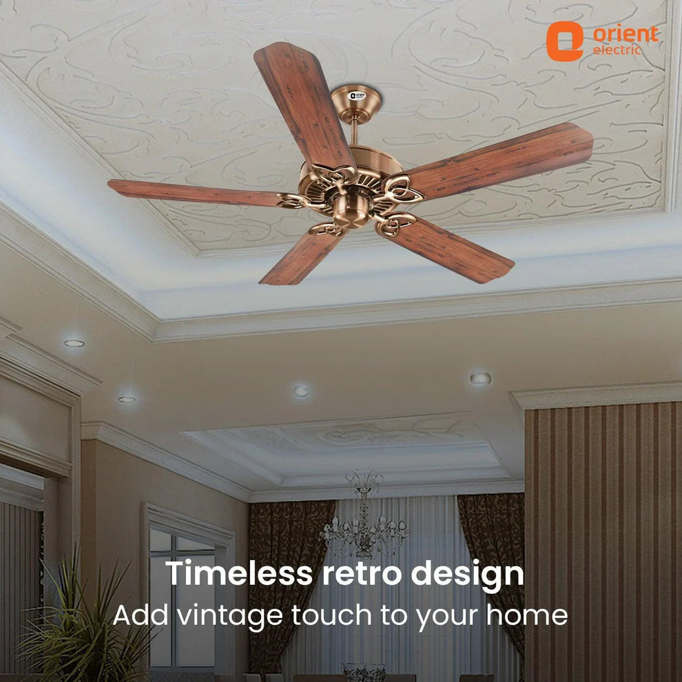 Ceiling fan with wooden blades in a room with decorative ceiling and lighting.