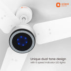 White Orient Electric ceiling fan with a black and silver circular accent and glowing blue LED lights, shown against a light gray ceiling background with product text and logo.