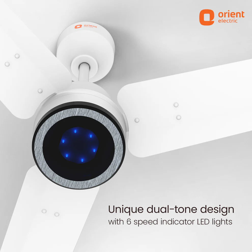White Orient Electric ceiling fan with a black and silver circular accent and glowing blue LED lights, shown against a light gray ceiling background with product text and logo.