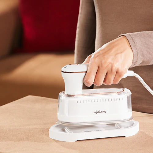 Lifelong LLGRMS901 1250W handheld garment steamer removing wrinkles from clothes, featuring a foldable design, rest stand, and 90ml water tank for quick, portable steaming at home or while traveling.