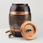 Antique style engraved copper water dispenser dispenser container with a spigot tap and a removable lid, featuring a traditional royal pattern.