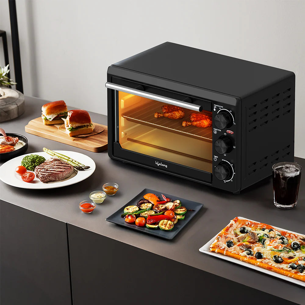 Lifelong LLOT20 20 Litre Oven Toaster Griller (OTG) in black, baking grilled chicken with temperature control knobs, ideal for baking cakes, pizzas, grilling vegetables, steaks, and toasting at home.